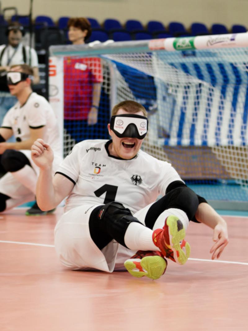 Male goalball player celebrates on the court