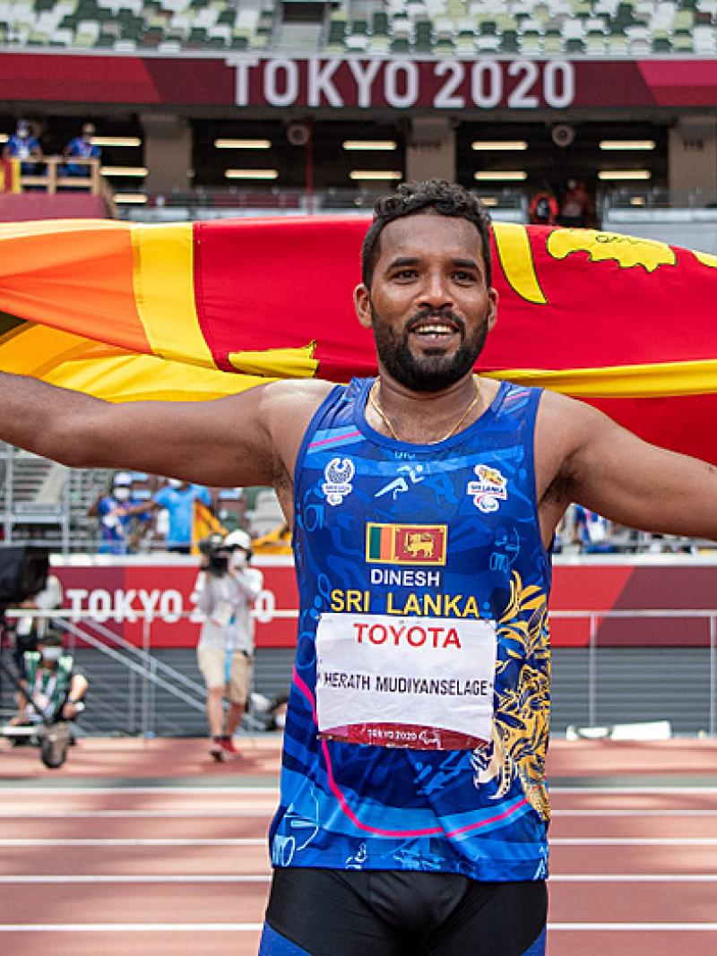 Sri Lankan male javelin thrower celebrates with country flag