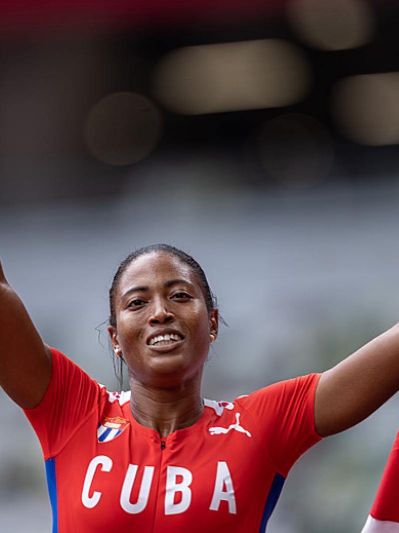 Cuban sprinter Omara Durand holds her coutry's flag and smiles after winning her sixth Paralympic gold