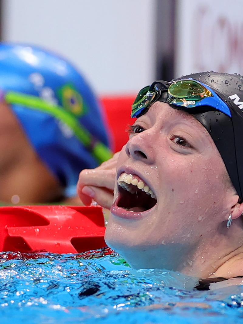 A woman with a big smile in the pool