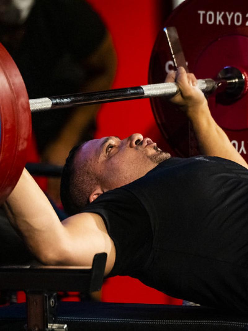 A man preparing to raise a bar on a bench press