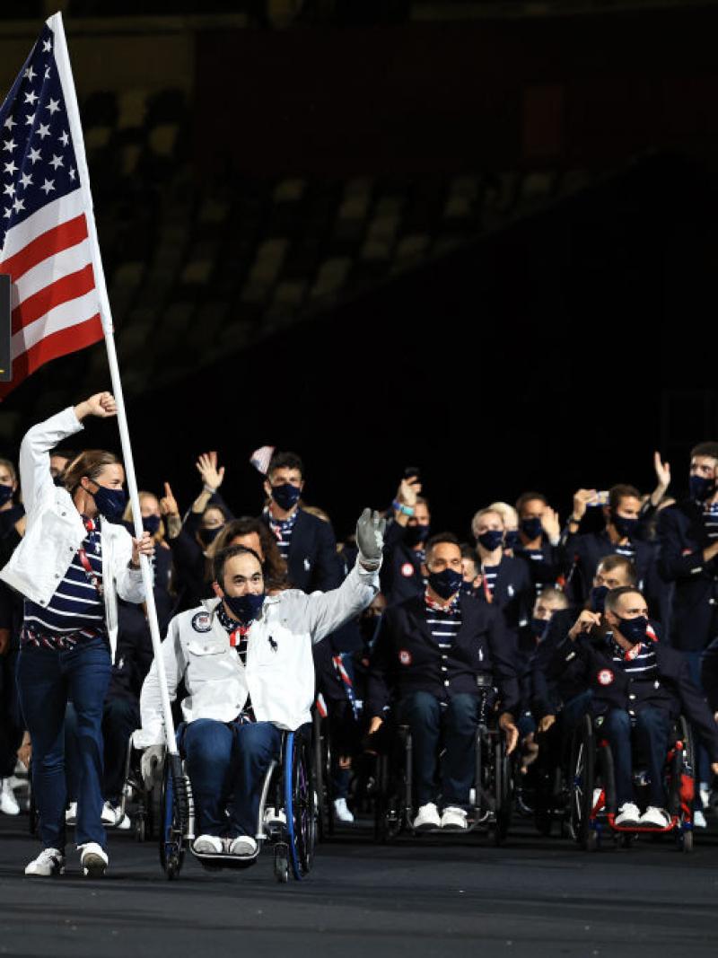 The USA delegation enters the Athletes' Parade at the Opening Ceremony of the Tokyo 2020 Paralympic Games with two flagbearers in front.