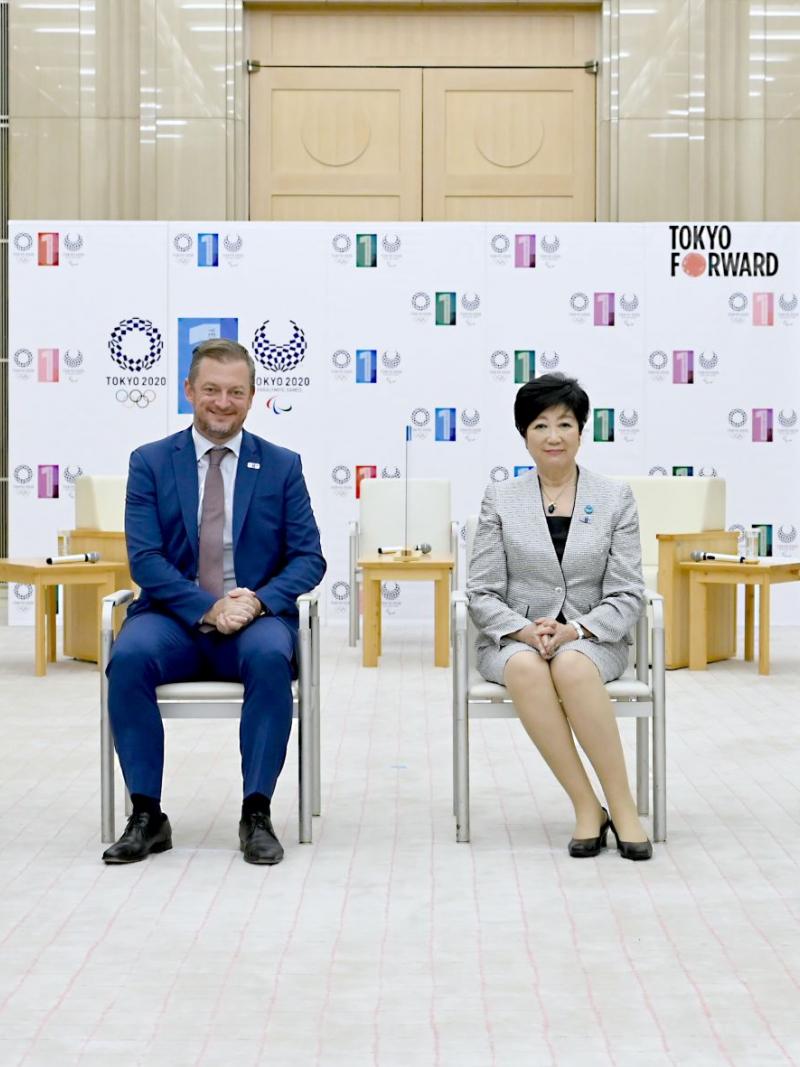Four people in official attire, two men and two women, pose for a photo.