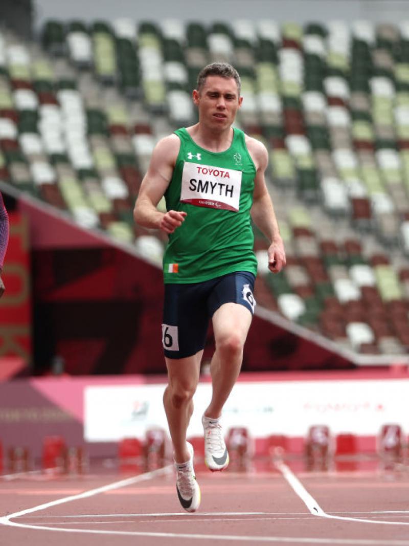 Three male athletes compete in a race.