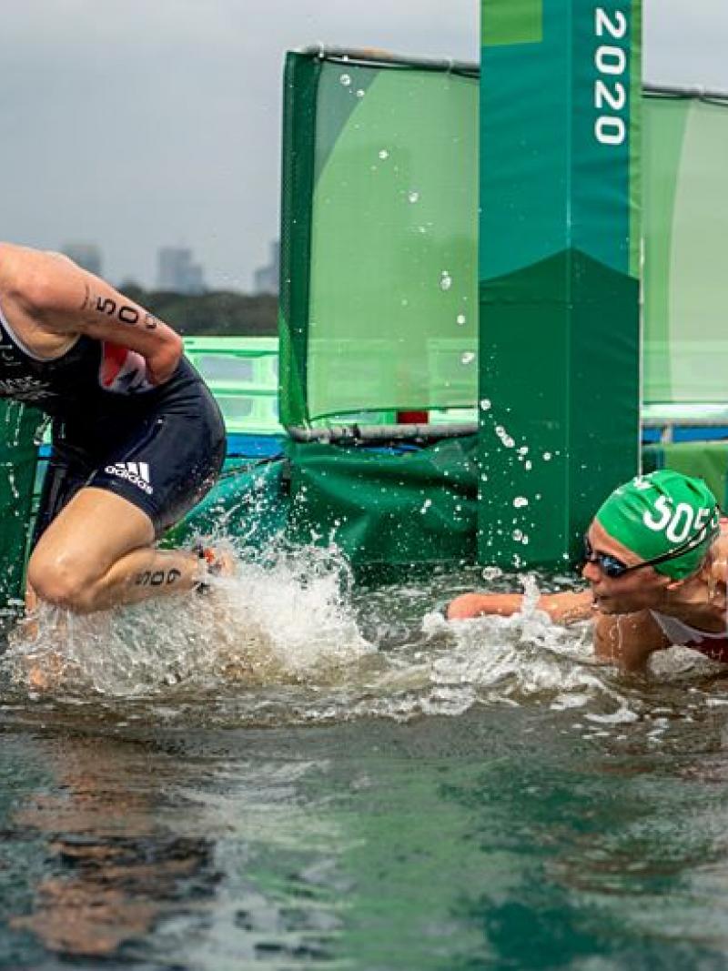 Two female Para triathletes are exiting the water