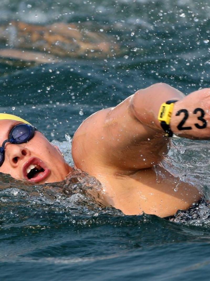 A female swimmer competing in an open water race