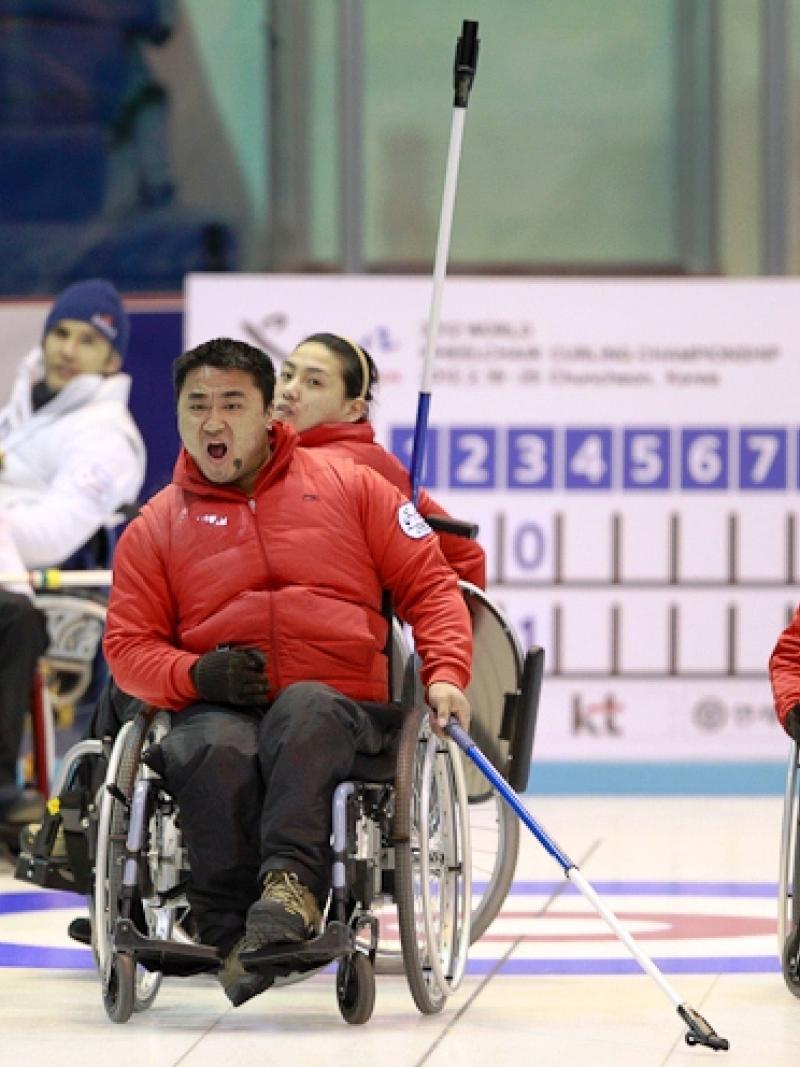 An athlete from the Korean Wheelchair Curling Team celebrates a point on Day 4 of the 2012 World Wheelchair Curling Championships
