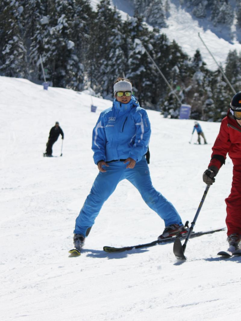 boy skiing with coach