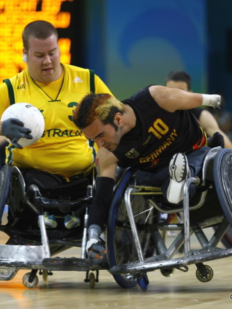 A picture of 2 Wheelchair Rugby players.
