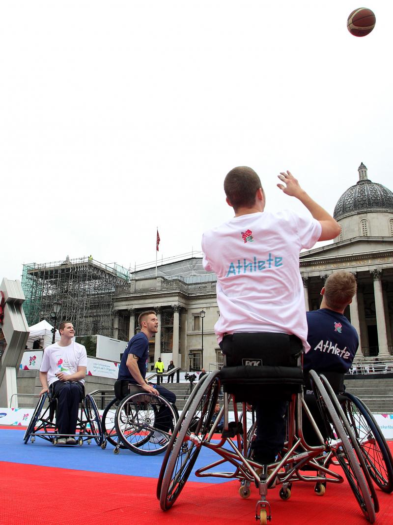 A picture of a man in a wheelchair playing Basketball
