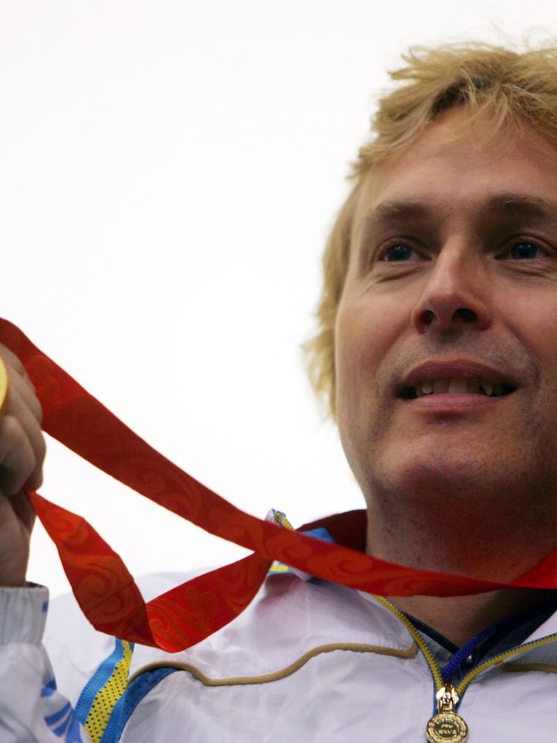 A picture of man showing his gold medal
