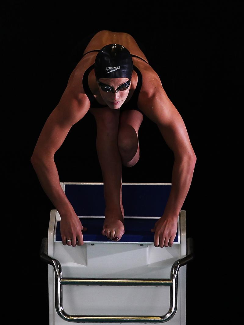 A picture of a woman jumping in a pool