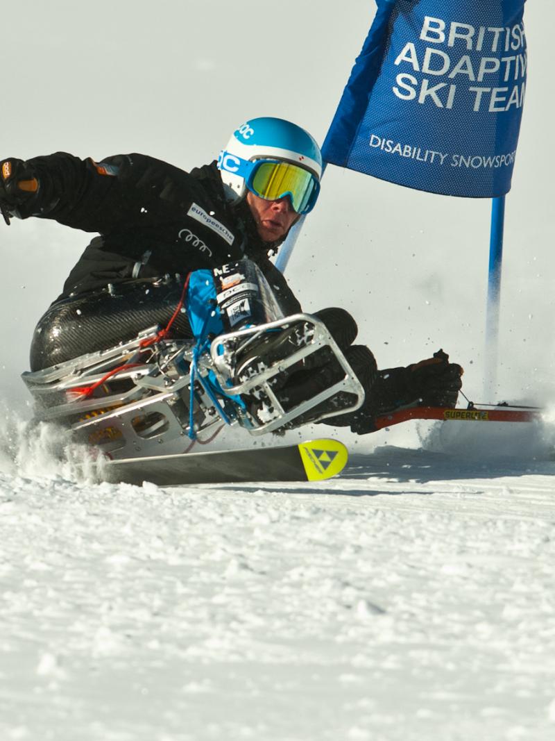A picture of a man in a sledge skiing