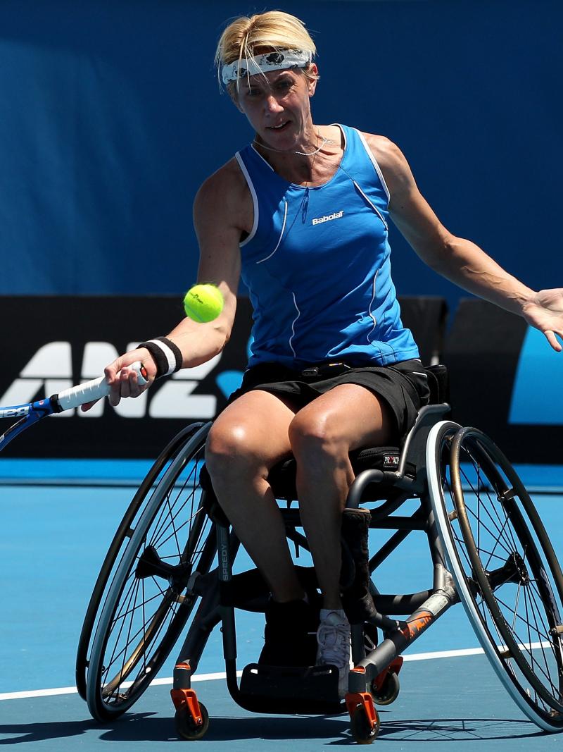 Germany's Sabine Ellerbrock sits in her wheelchair and hits a tennis ball.