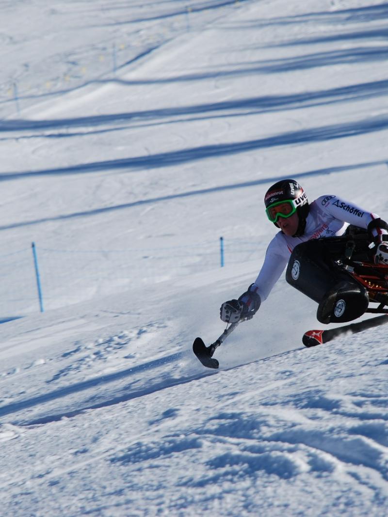 A picture of a woman skiing on a hedge.