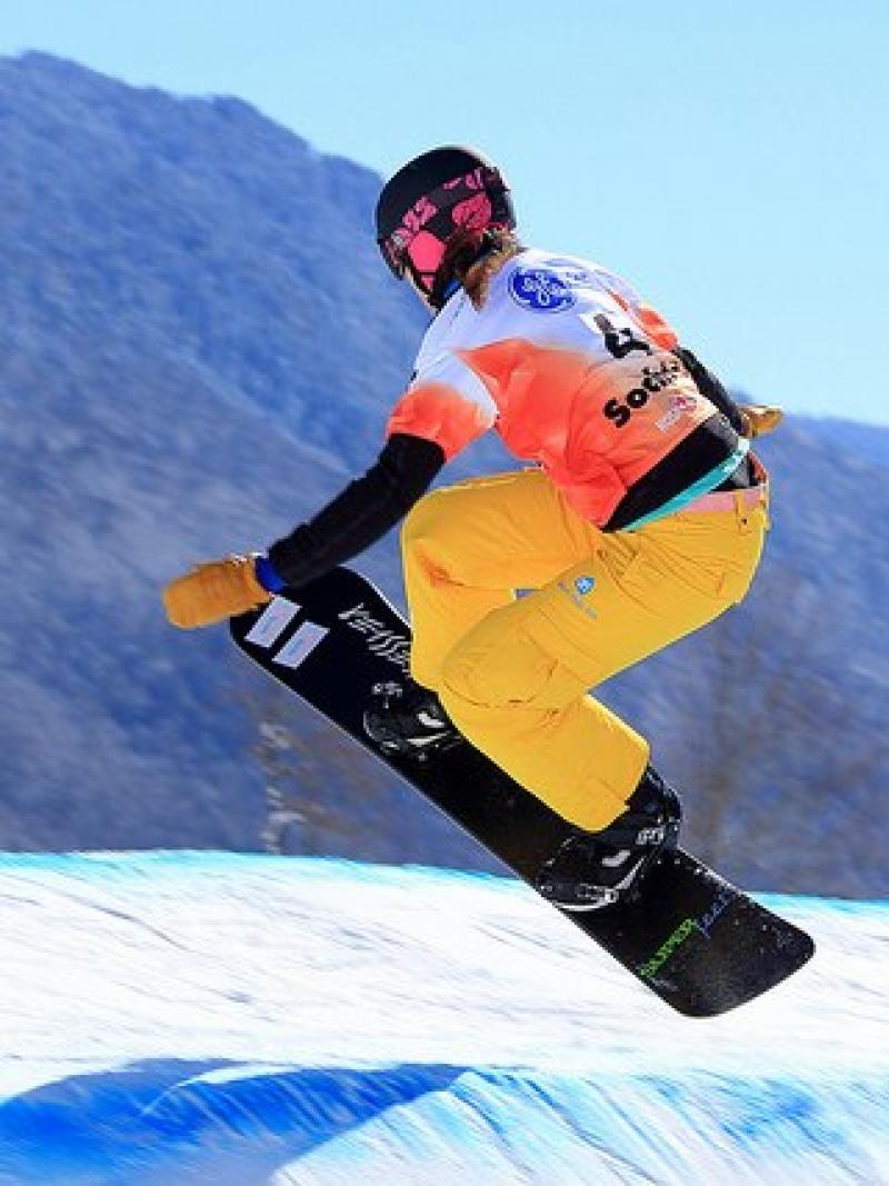 A picture of a woman doing snowboarding.