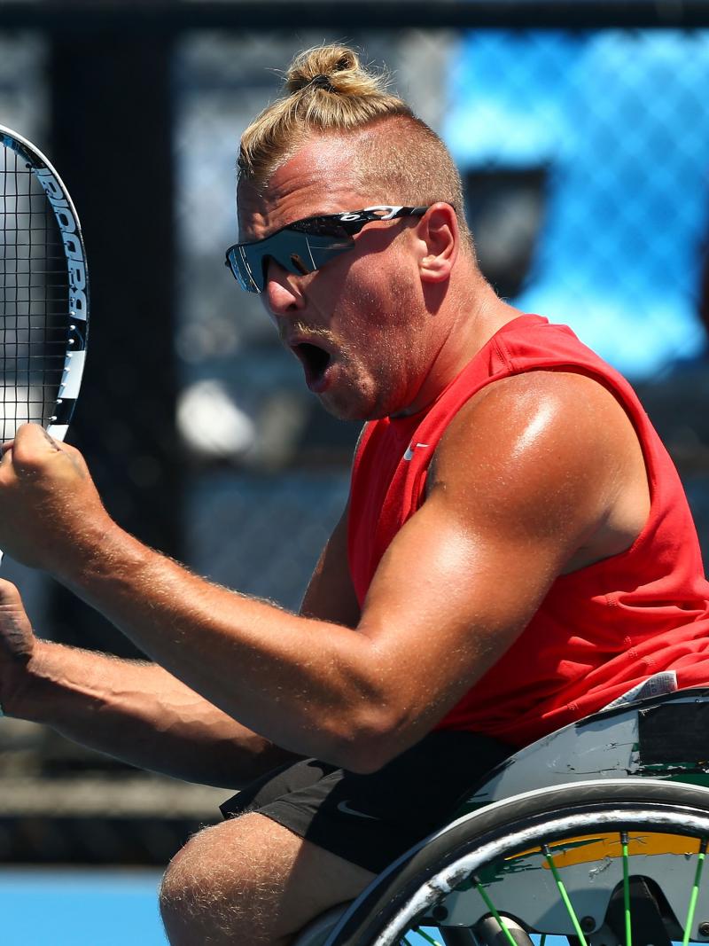 Dylan Alcott celebrates winning his quad wheelchair tennis singles match against Great Britain's Andy Lapthorne at the 2014 Australian Open.