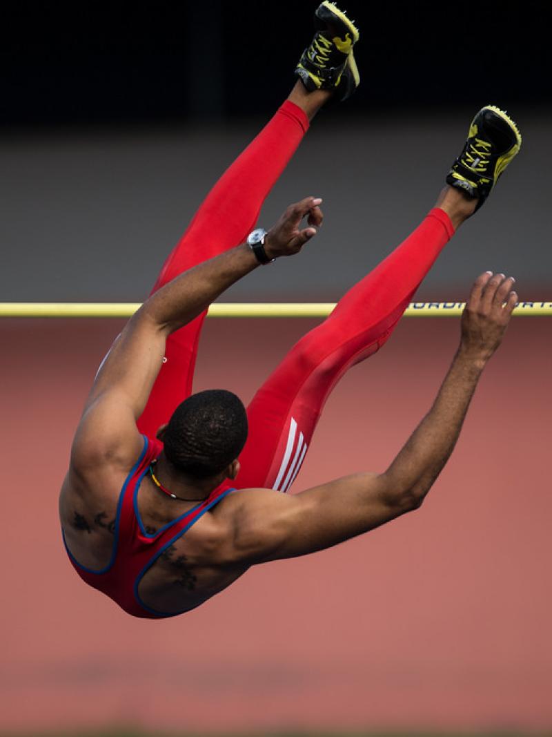 The back of Luis Felipe Gutierrez Rivero is seen as he jumps over the high bar.