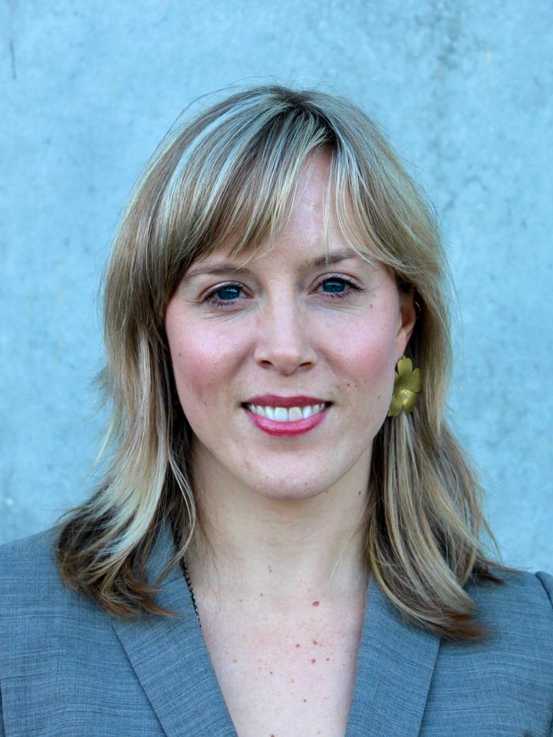 A woman is staring at the camera in a horizontal portrait shot. 