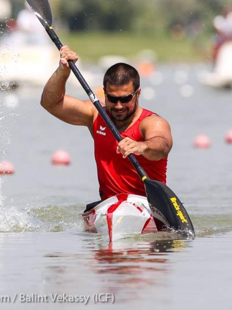 A man paddles in a canoe.