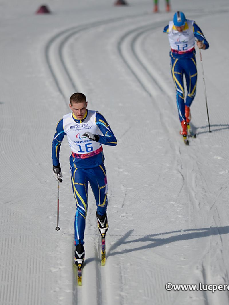 Ukrainian Ihor Reptyukh skis at Sochi 2014 followed closely by a competitor