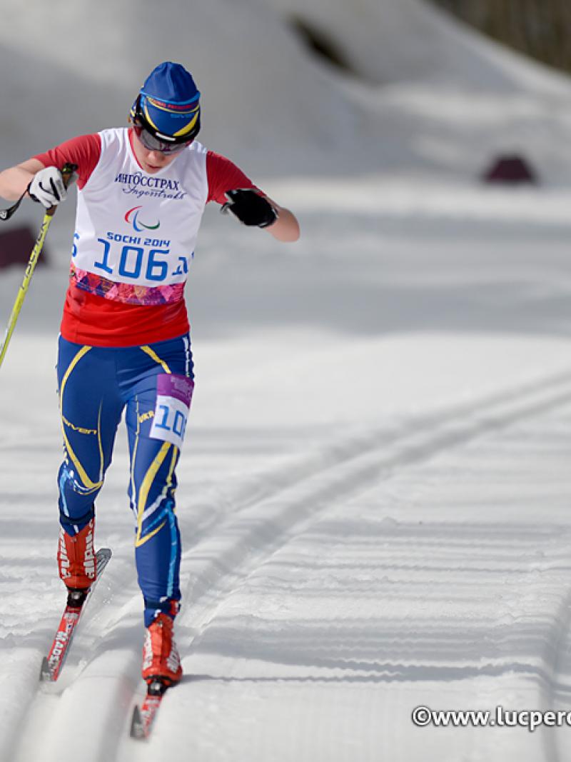 Cross country skier in race suit in a slope