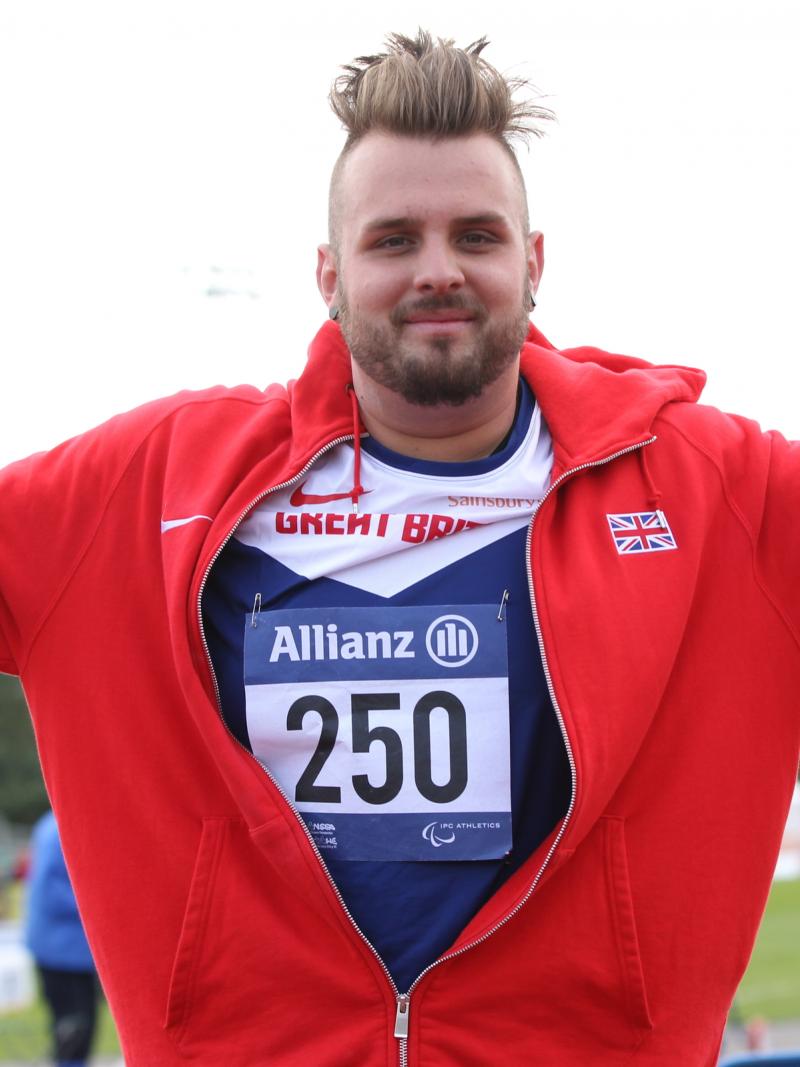 Man celebrating, wearing a red jacket