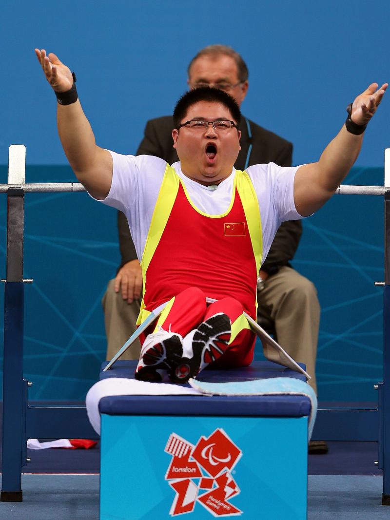 Gu Xiaofei, China, celebrating his lift, lifting up his arms.