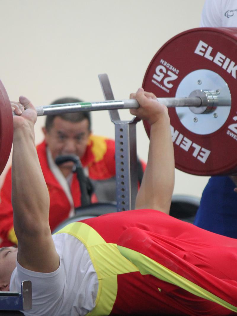 Powerlifter on a bench lifting a bar