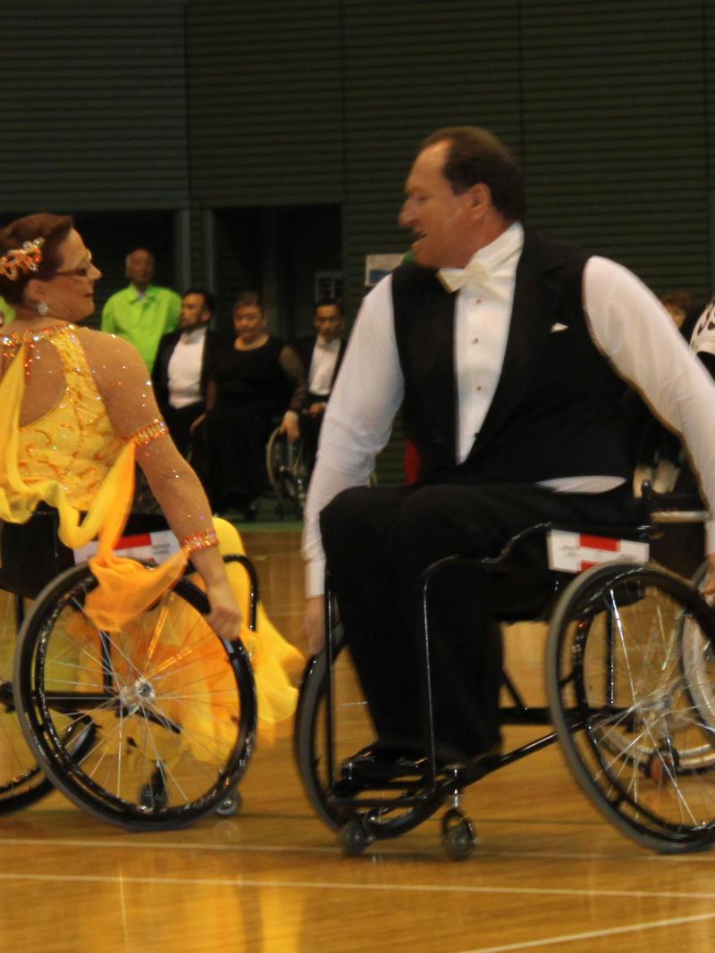 Two dancers in wheelchairs posing during a performance