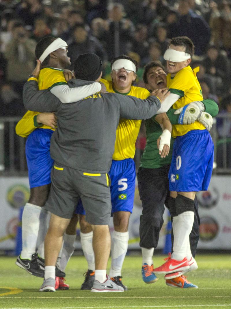 Blindefolded football team celebrating