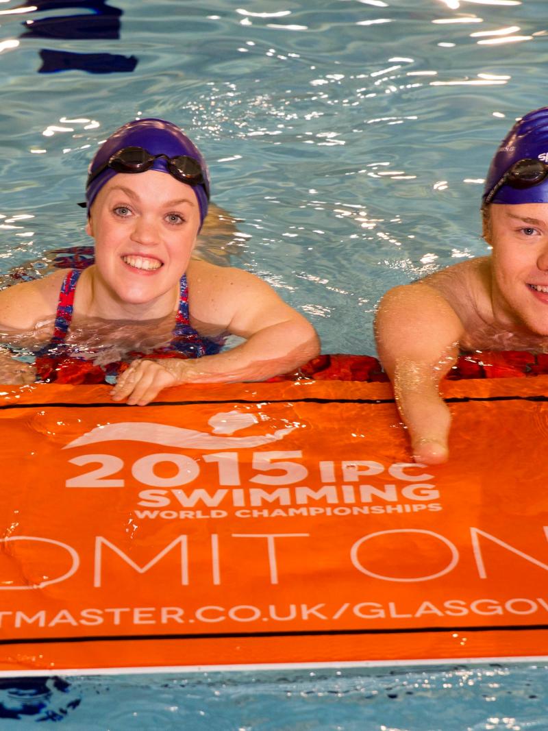 Ellie Simmonds and Andrew Mullen in the pool with a huge ticket in hand