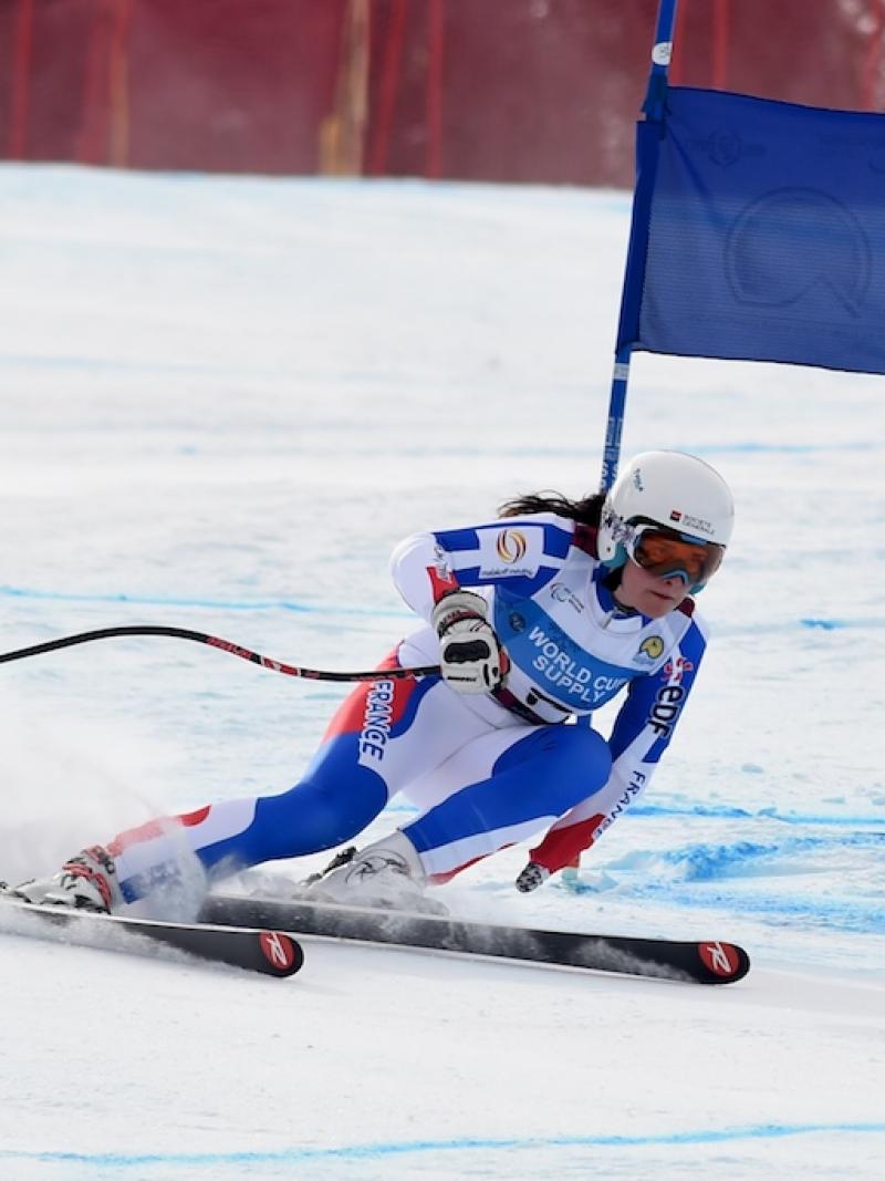 A female standing skier competes in super-G