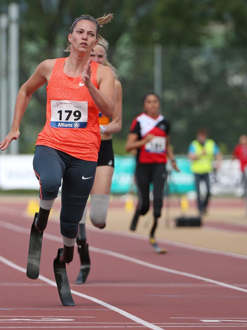 A blade runner crossers the finish line ahead of her rivals.