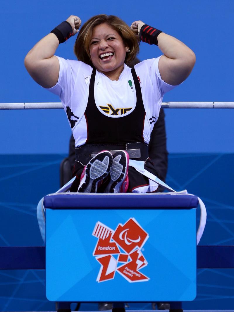 A picture of a powerlifter on a bench celebrating