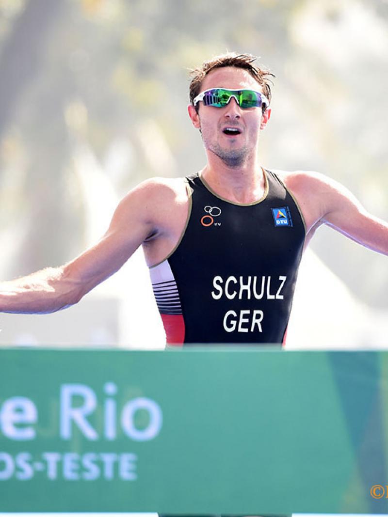 Man with an arm amputation crossing a finish line