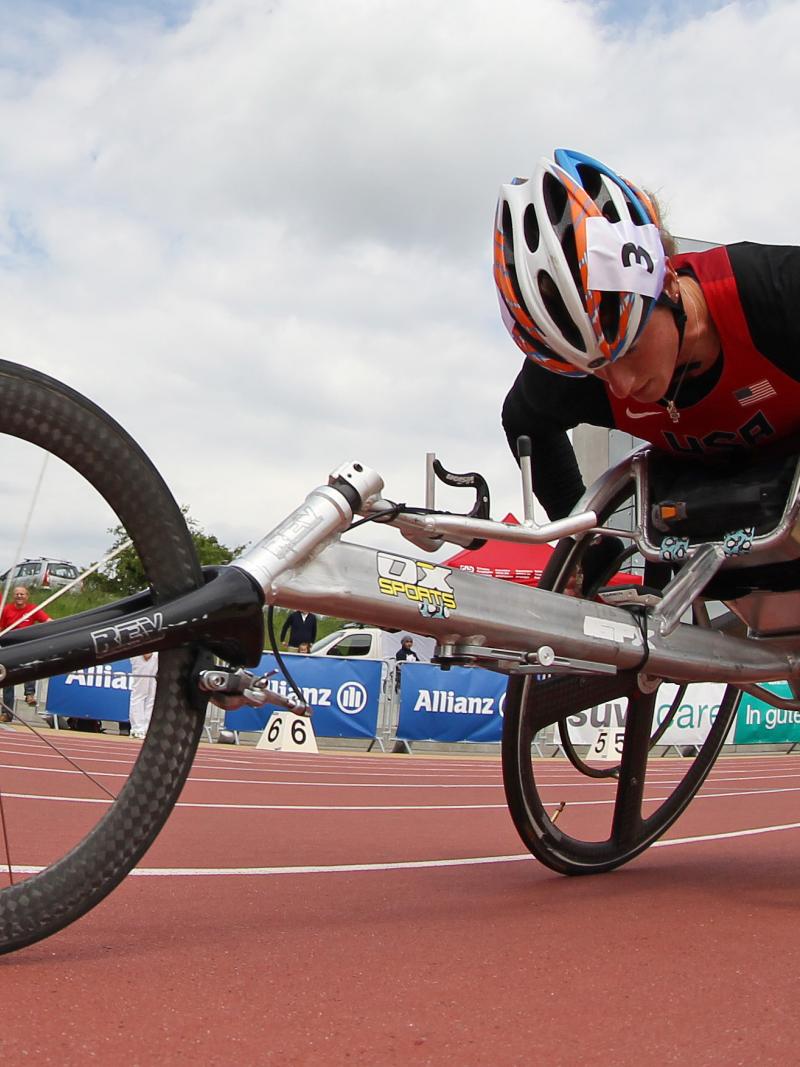 Woman in a racing wheelchair competing