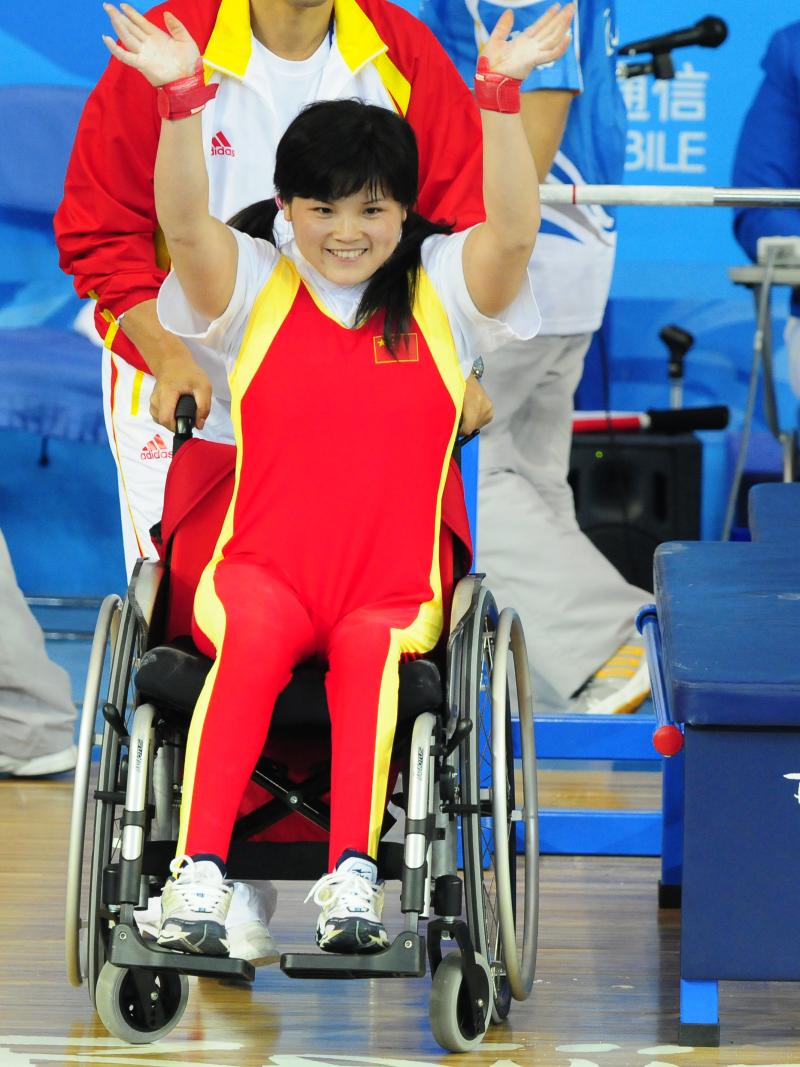 A Chinese powerlifter celebrates winning gold in powerlifting at her home Paralympic Games.