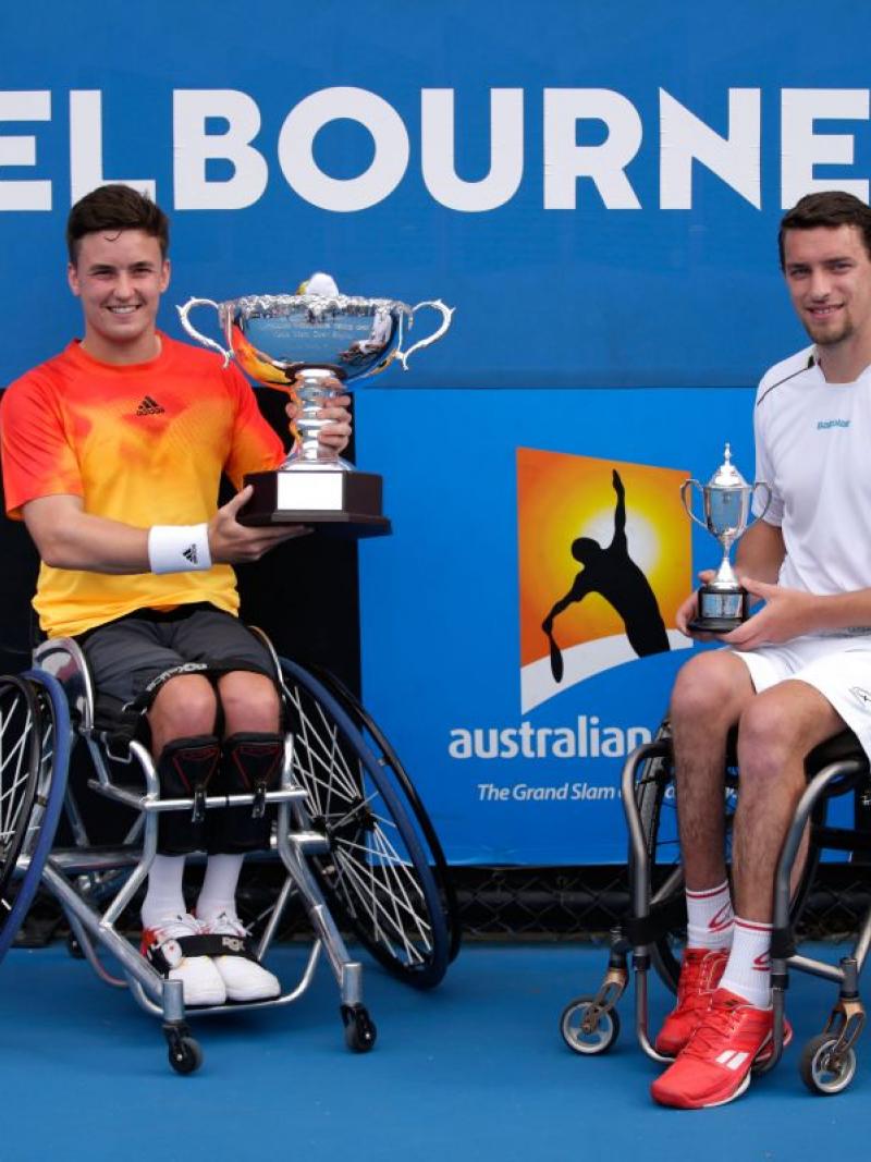 Wheelchair tennis player lifts the Australian Open trophy