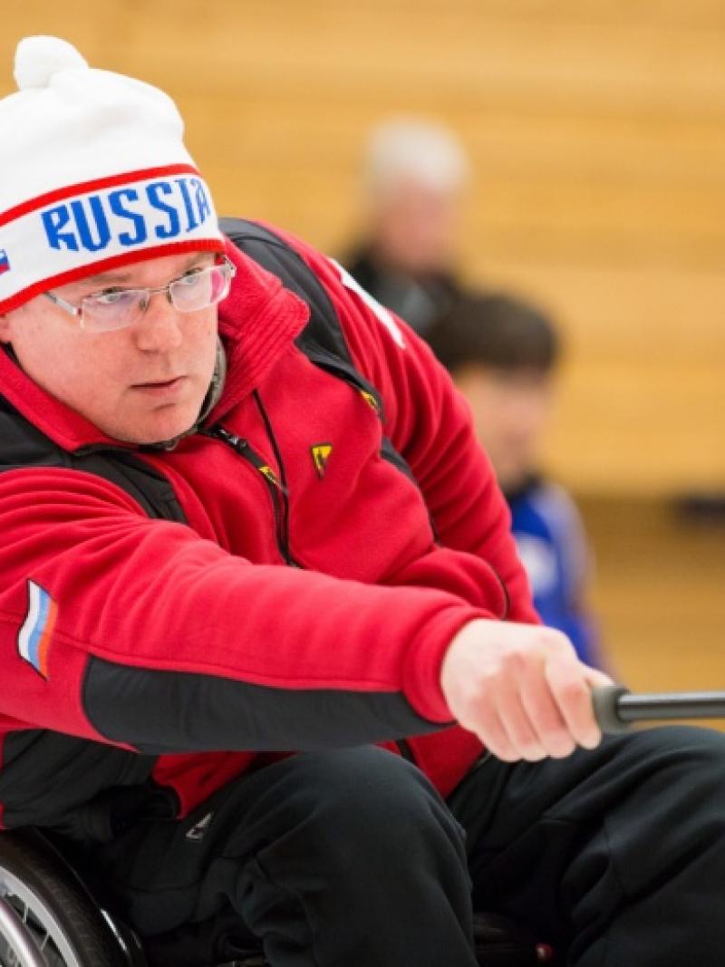 Man in wheelchair curling