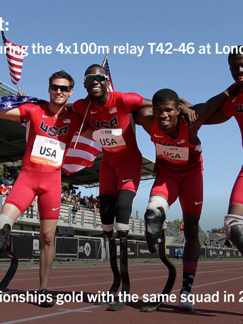 Four men with prosthesis celebrate on a track with USA flags
