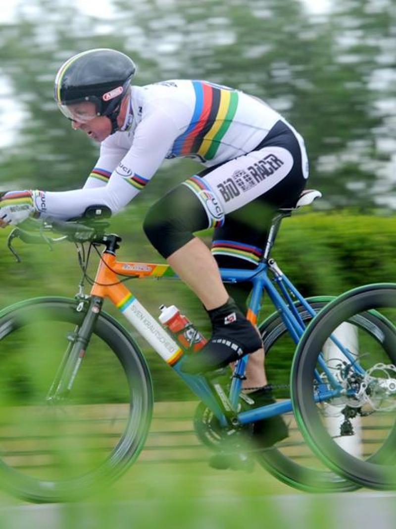 Man on tricycle racing on the road