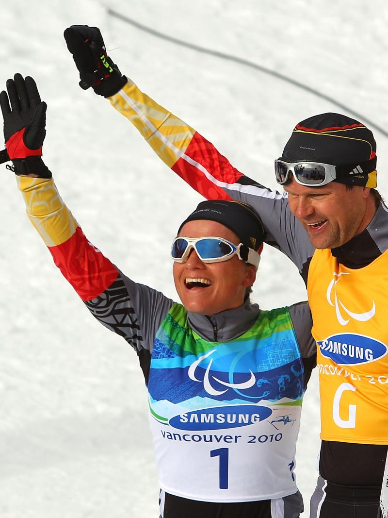 Verena Bentele and her guide Thomas Friedrich of Germany celebrate winning the Women's 3km Pursuit Visually Impaired Biathlon at the 2010 Vancouver Winter Paralympics.