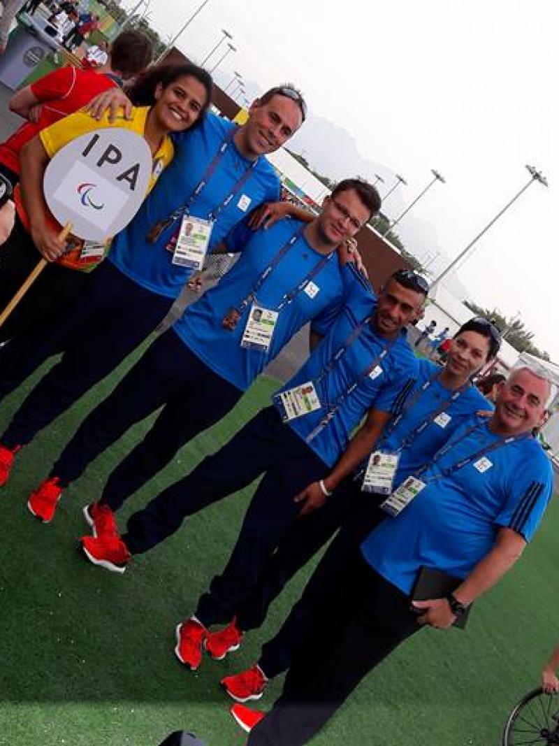 A group of people pose at the Rio 2016 Athlete Village
