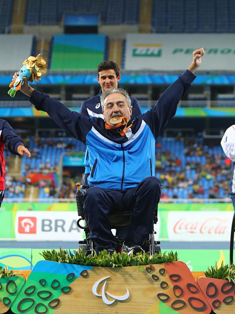 Gold medalist Zeljko Dimitrijevic of Serbia poses on the podium at the medal ceremony for Men's Club Throw - F51