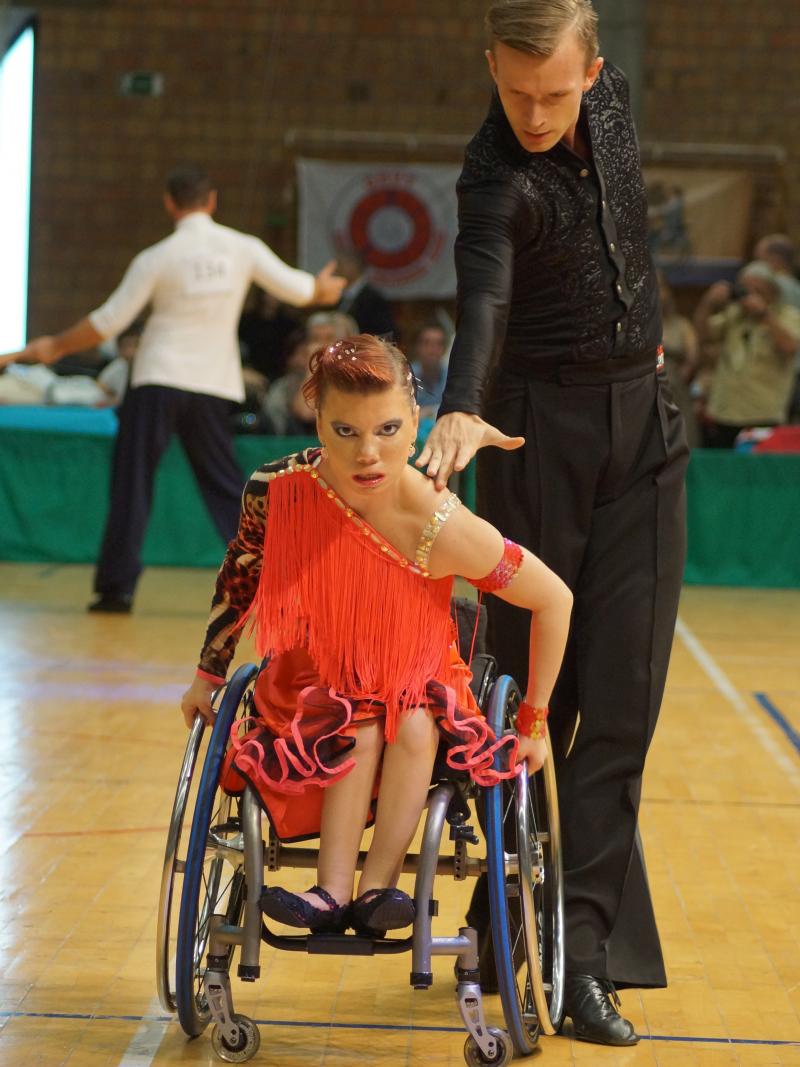 A woman in a wheelchair dances with a standing partner