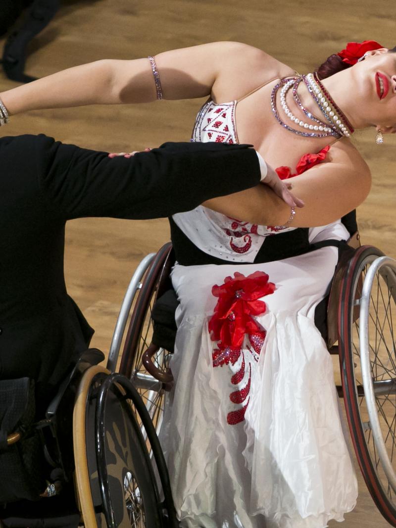 A man and woman in wheelchairs dancing