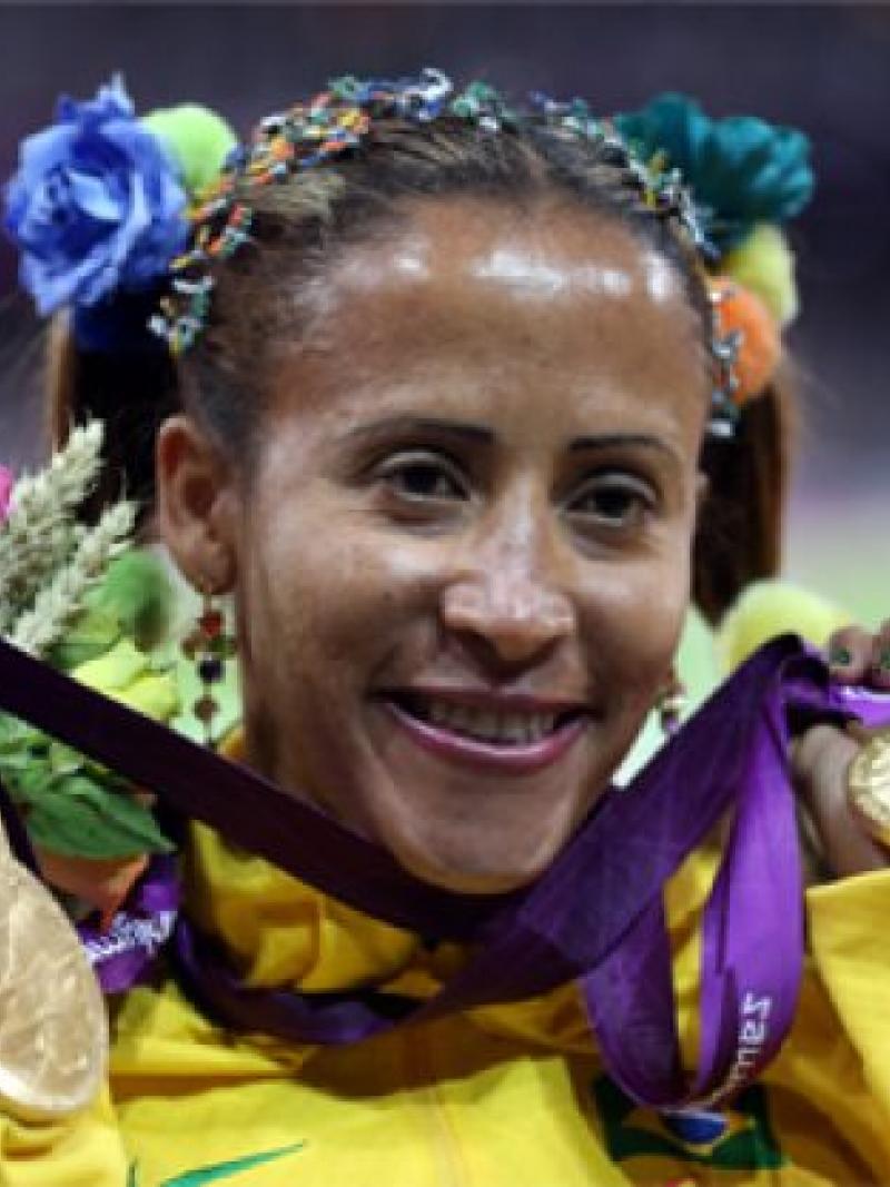 A picture of a woman showing her both gold medals
