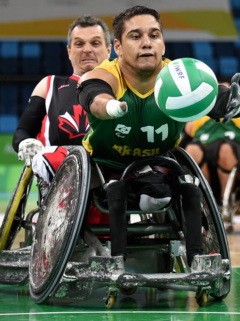 A wheelchair rugby player chasing for the ball