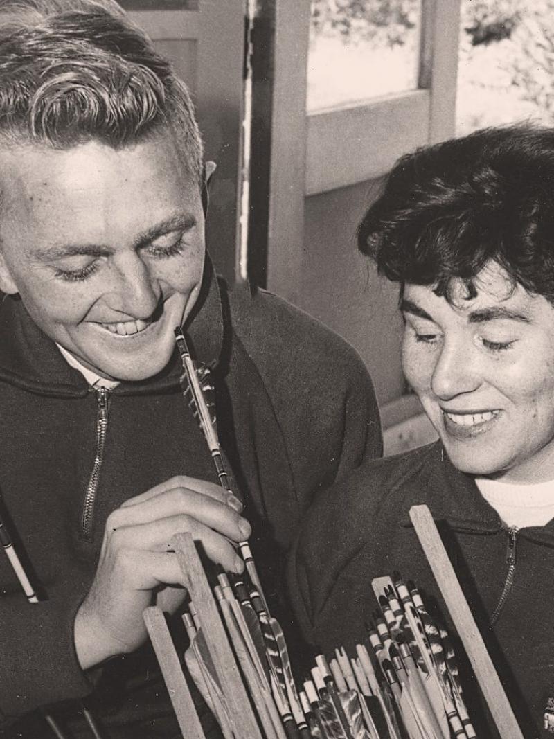 A smiling couple on a black and white picture